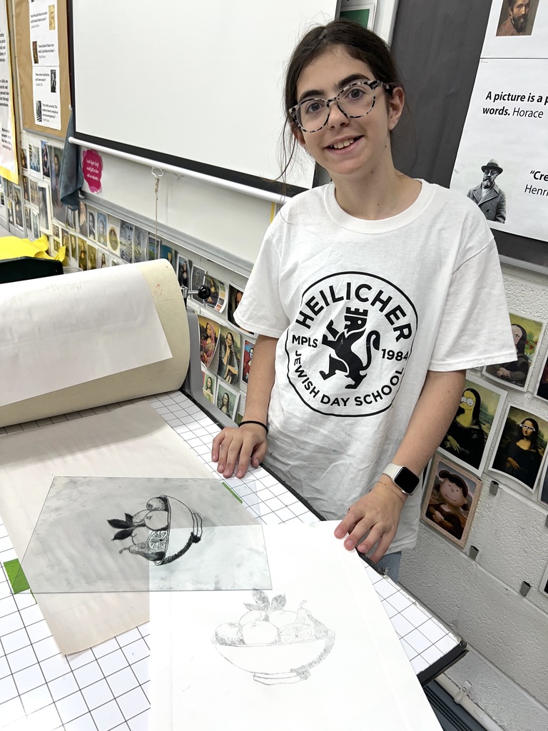 student with original and printed artwork