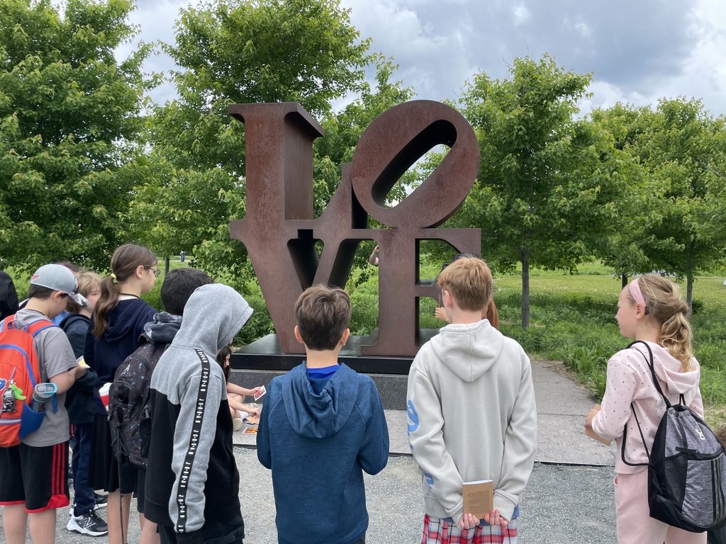 students look at LOVE sculpture