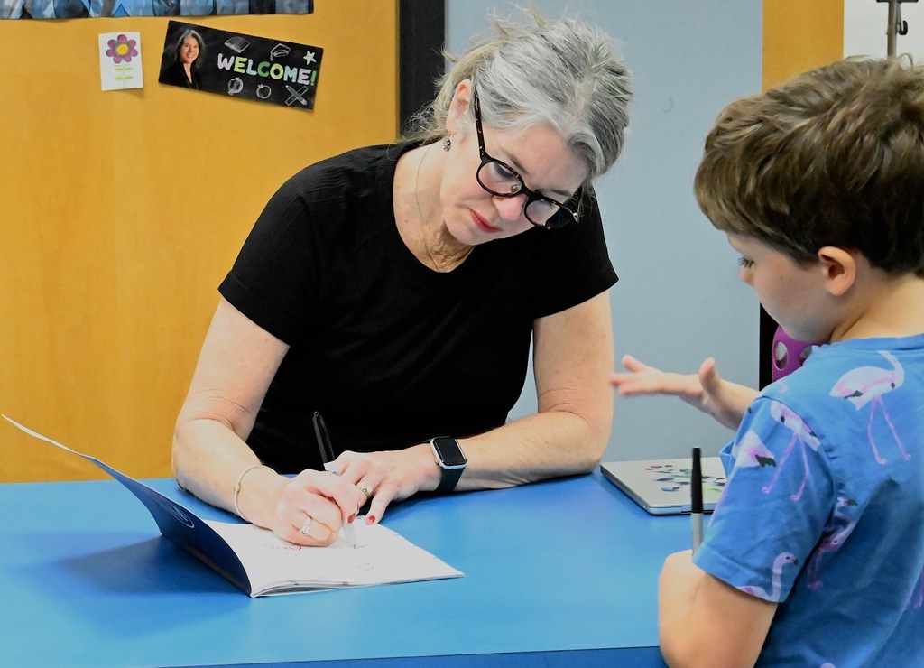 librarian signs student's yearbook