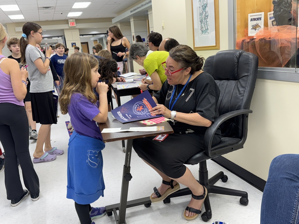 teacher signs student's yearbook