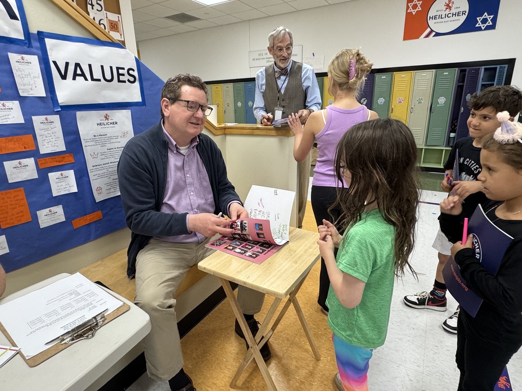head of school signs student's yearbook