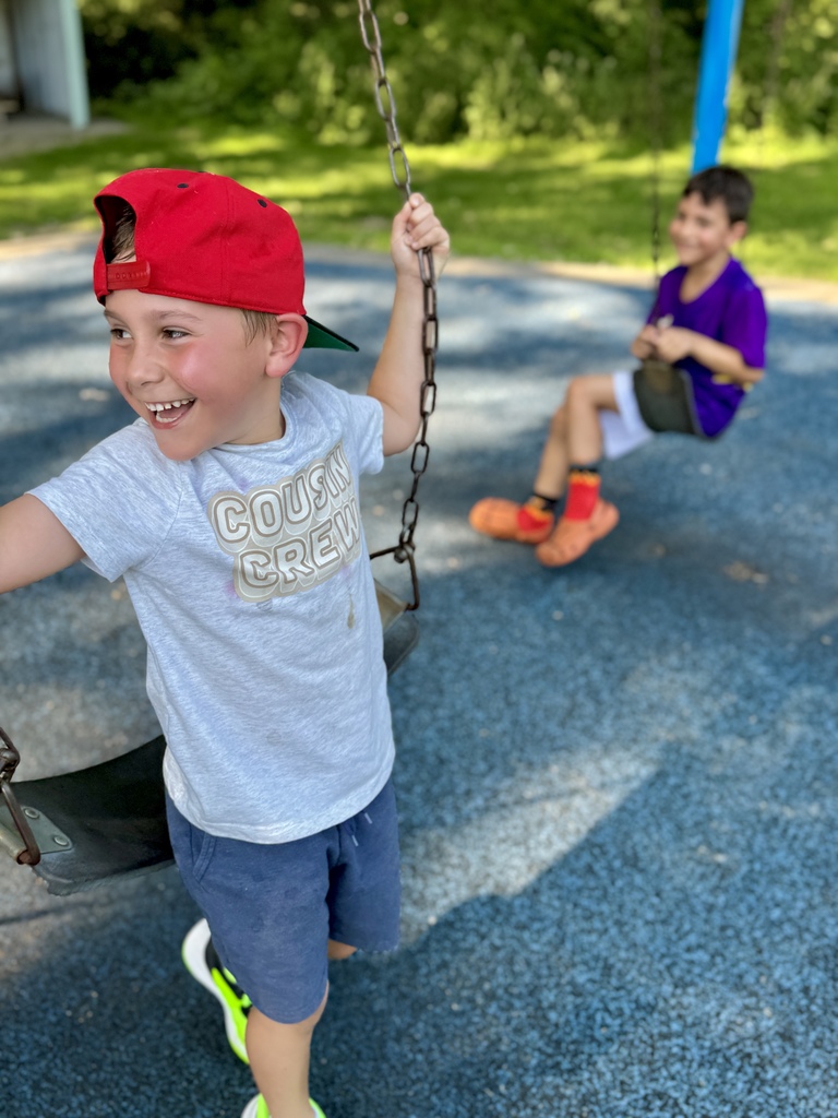 kids smiling on swings