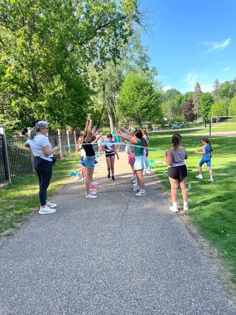 Girls on the Run team cheers on teammate as she crosses finish line