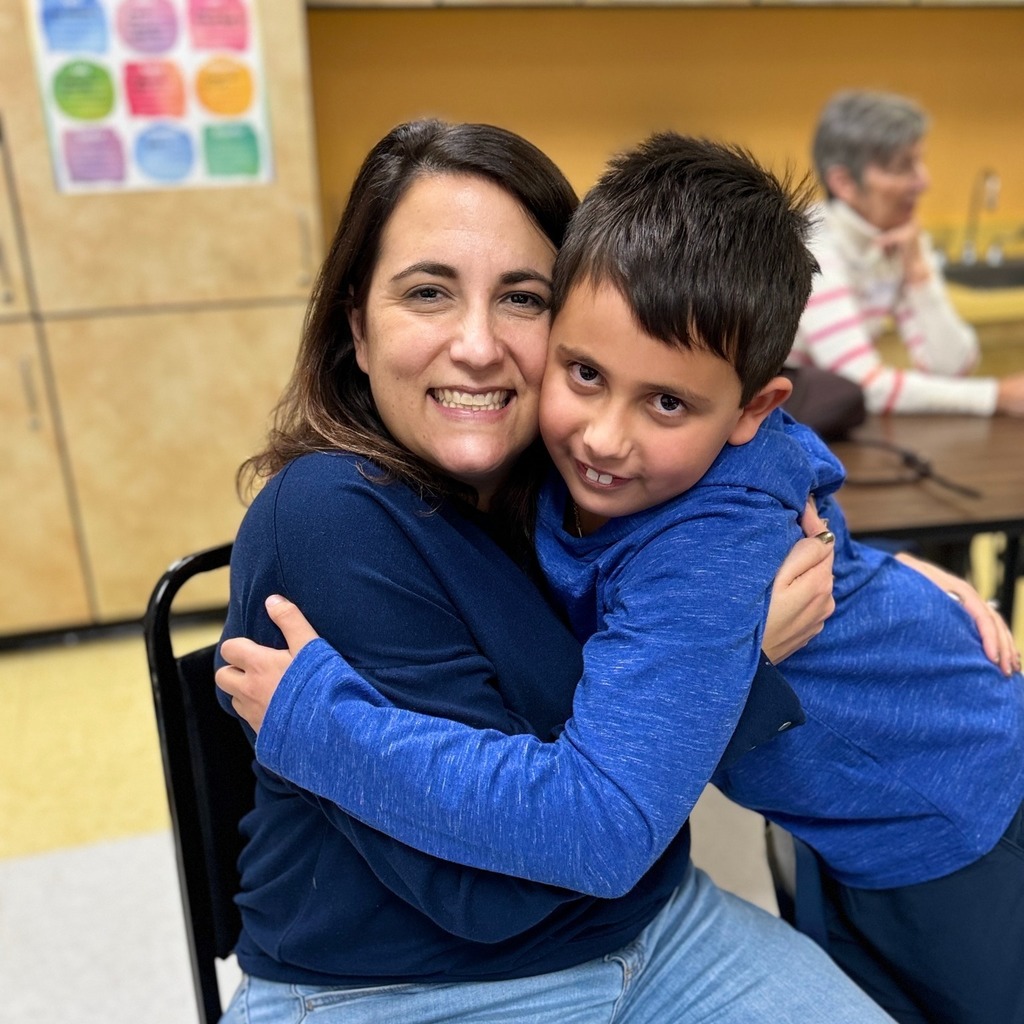 student and parent hug