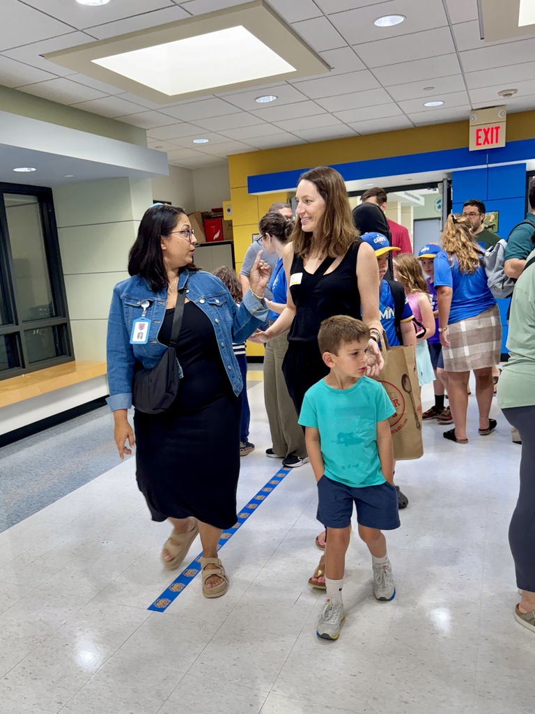 teacher and family walk through school