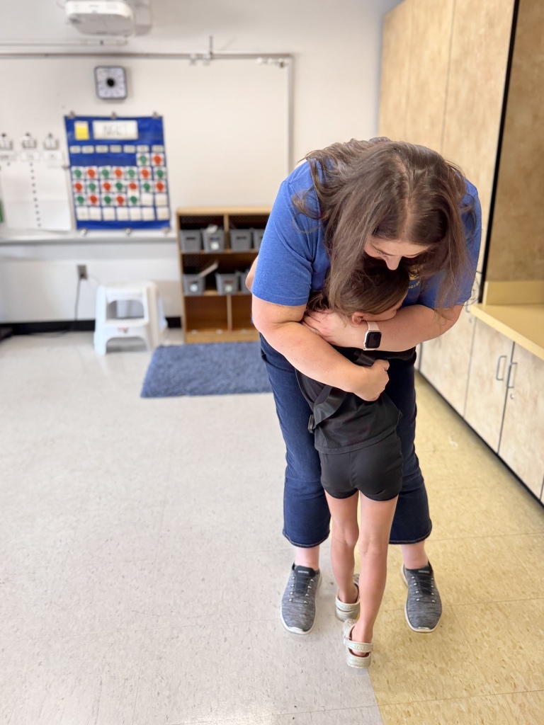 teacher and student hug