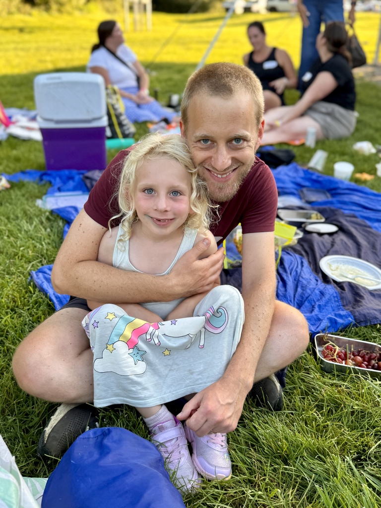 grownup and child picnic and smile