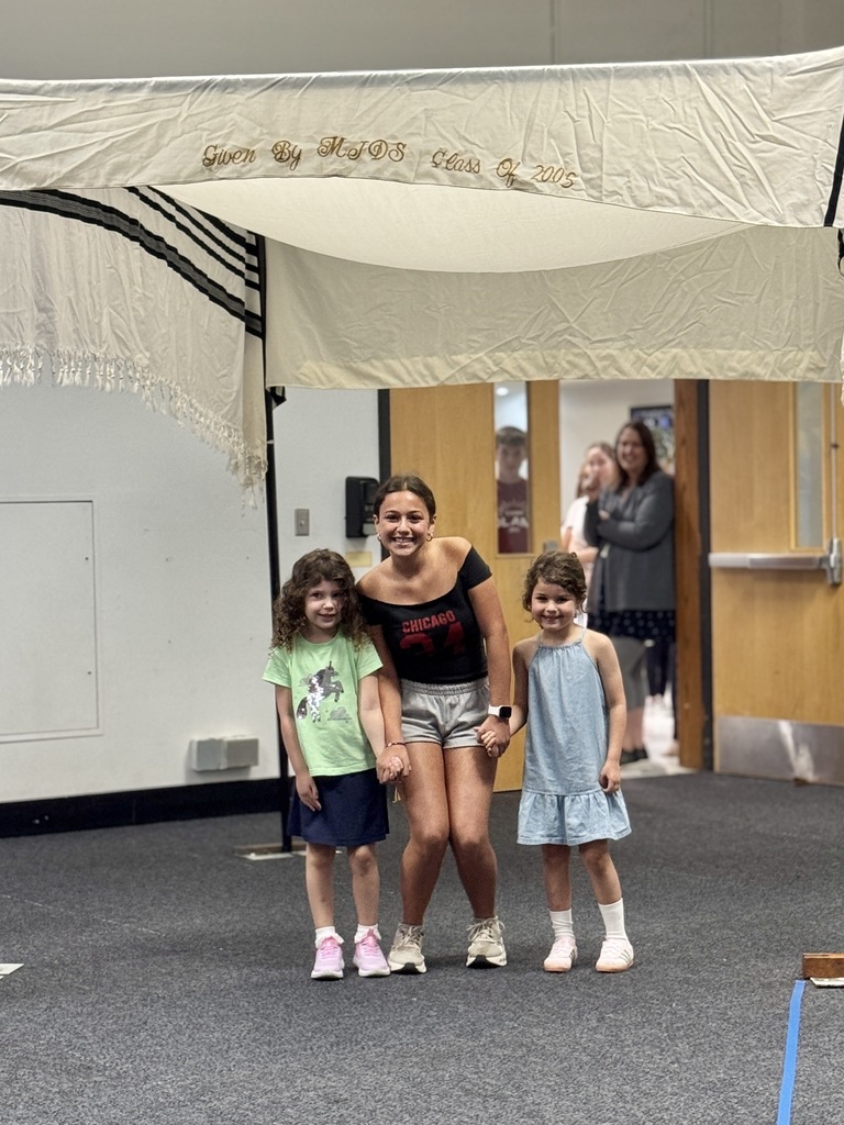 K-8 buddies walk through chuppah at Smith Opening Ceremony