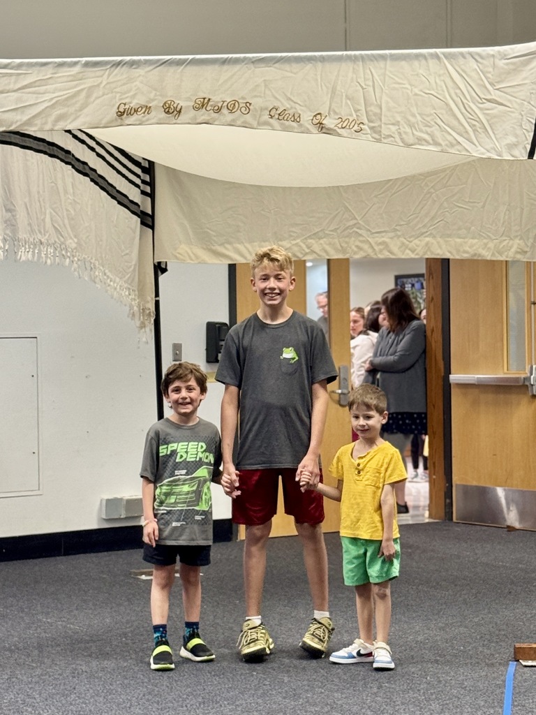 K-8 buddies walk through chuppah at Smith Opening Ceremony