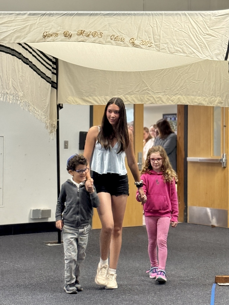 K-8 buddies walk through chuppah at Smith Opening Ceremony