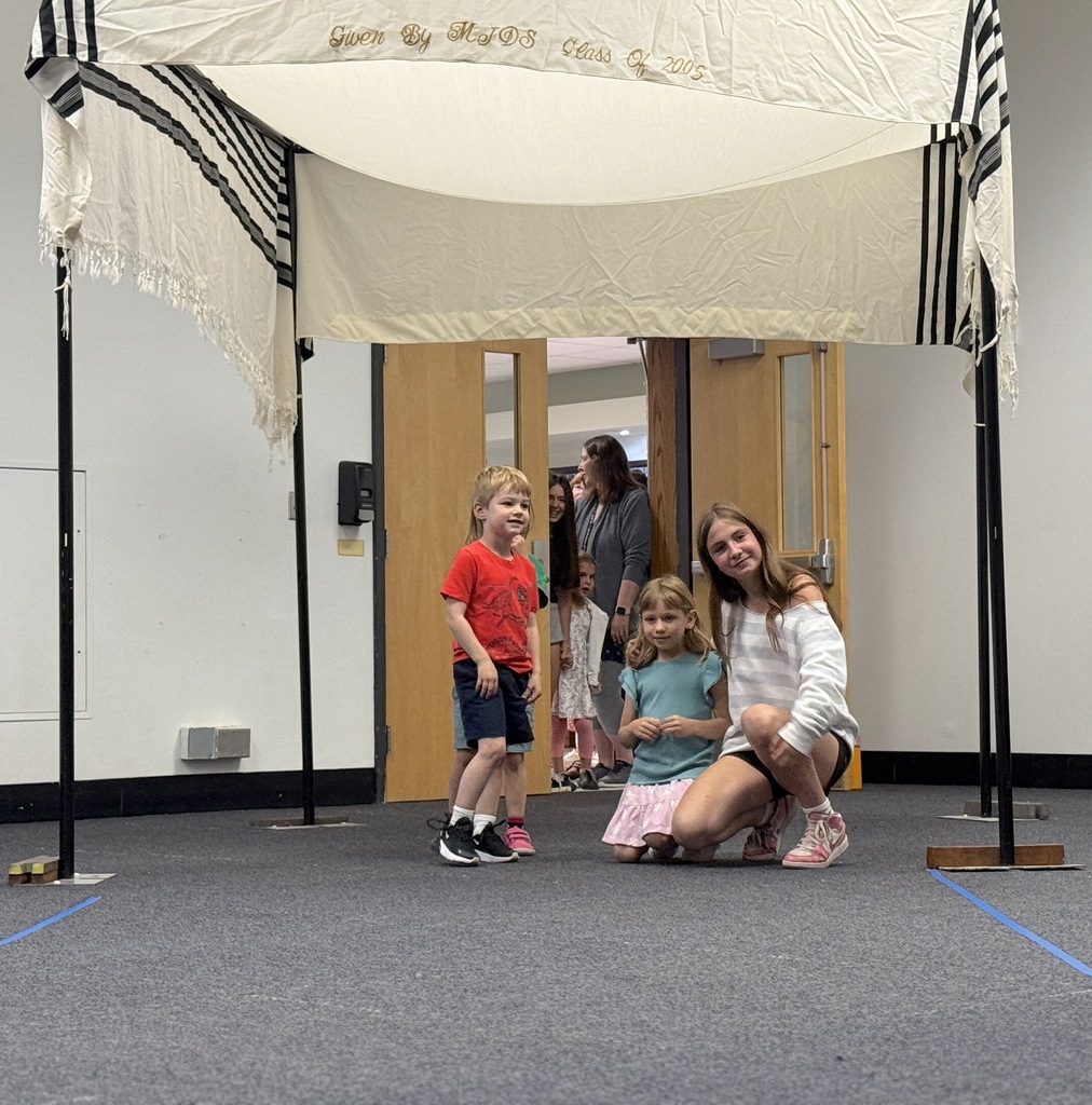 K-8 buddies walk through chuppah at Smith Opening Ceremony