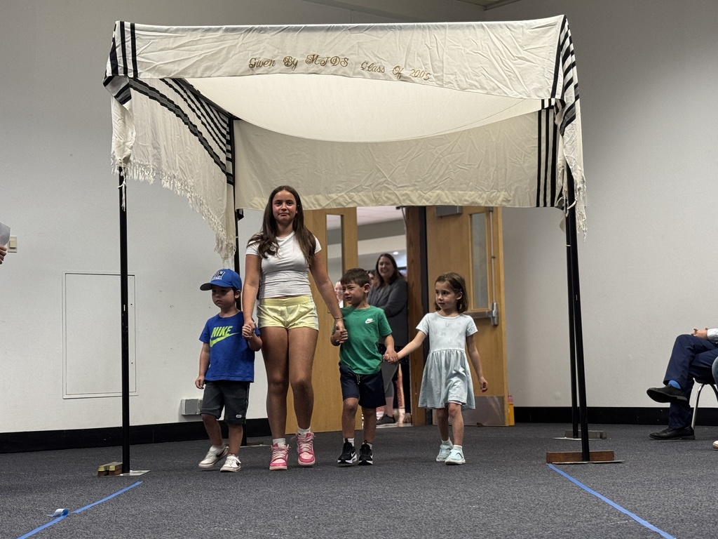 K-8 buddies walk through chuppah at Smith Opening Ceremony