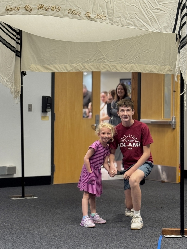 K-8 buddies walk through chuppah at Smith Opening Ceremony