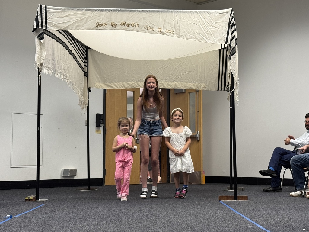 K-8 buddies walk through chuppah at Smith Opening Ceremony