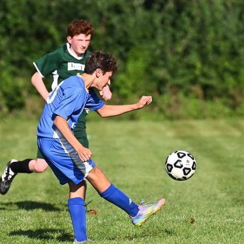 Smith student kicks soccer ball