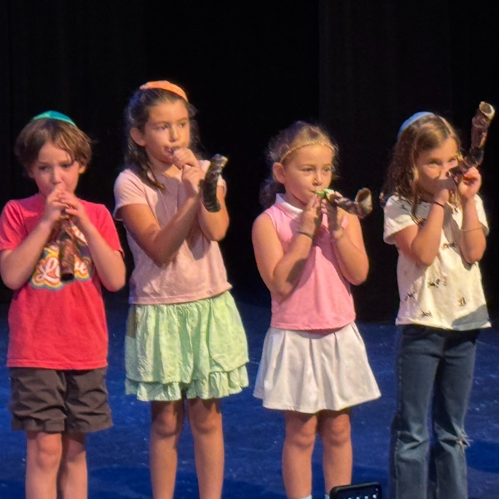 students blow shofar