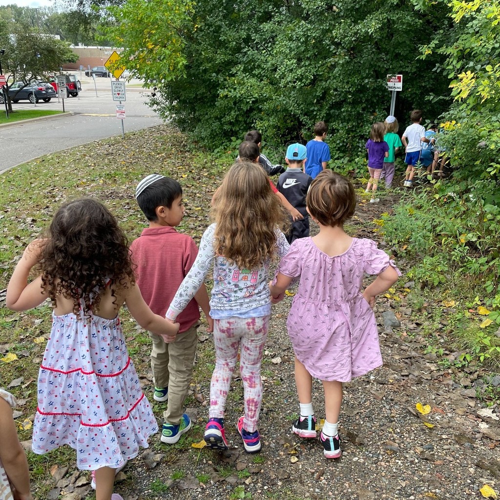 students hold hands on tashlikh walk