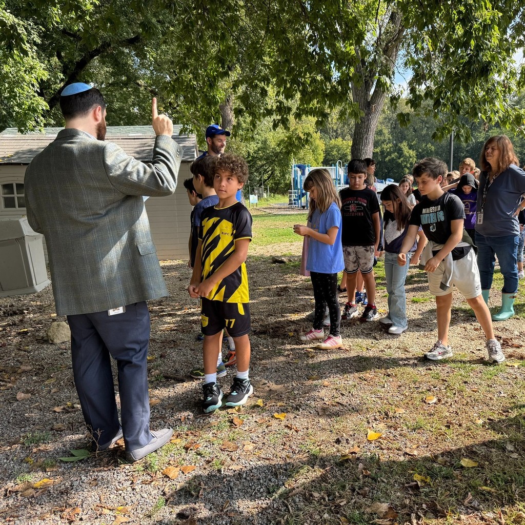 rabbi reads prompt on tashlikh walk