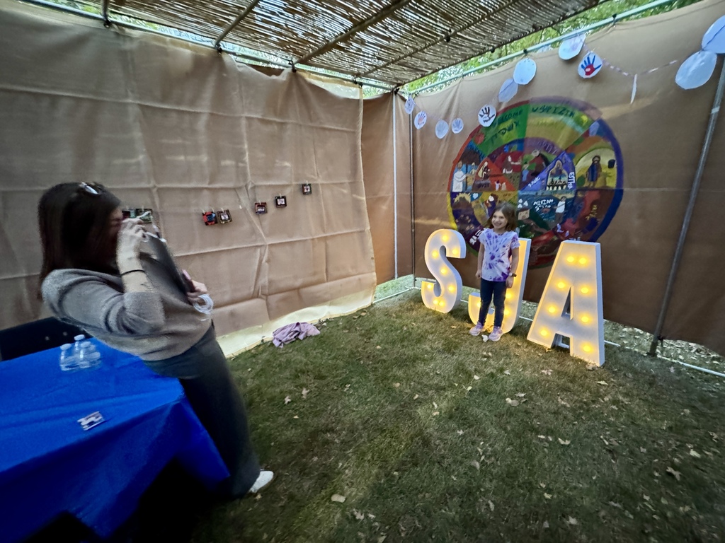 staff takes photo of student for art project