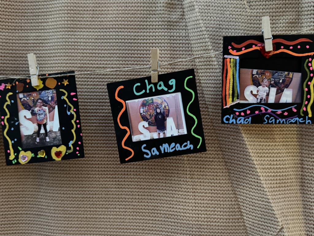 complete art projects decorate the sukkah: student pictures in decorated frames