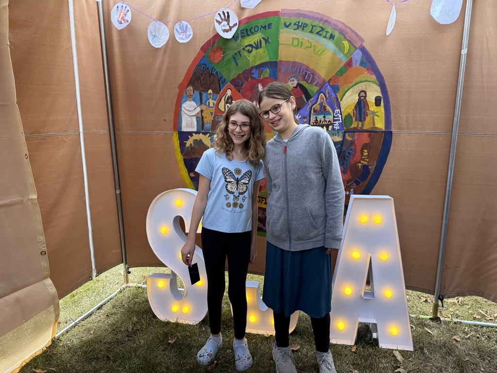 students pose for photo for art project