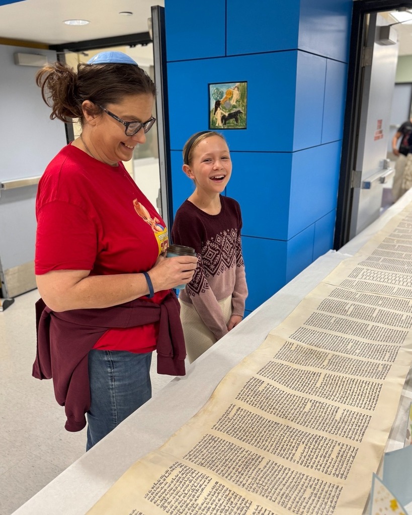 Morah Esther and student look at Torah