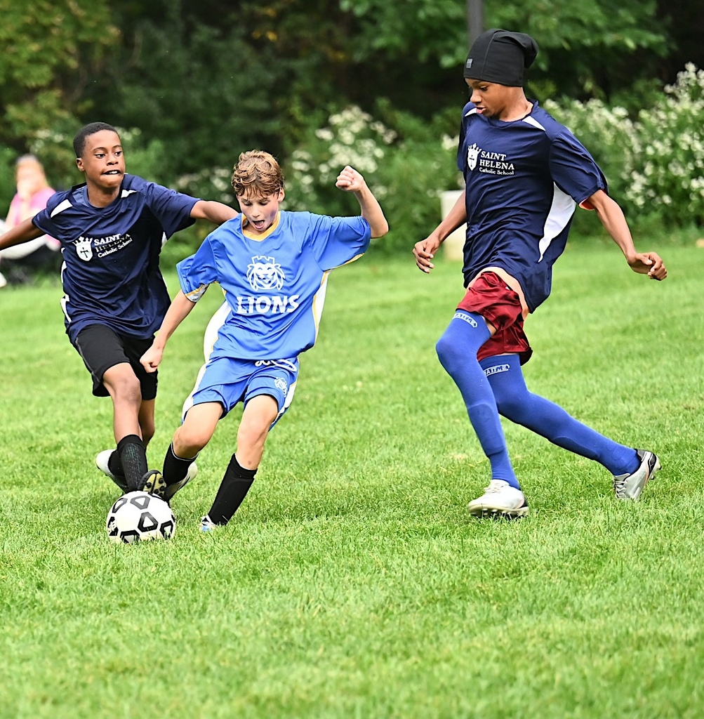 student dribbles ball through defenders