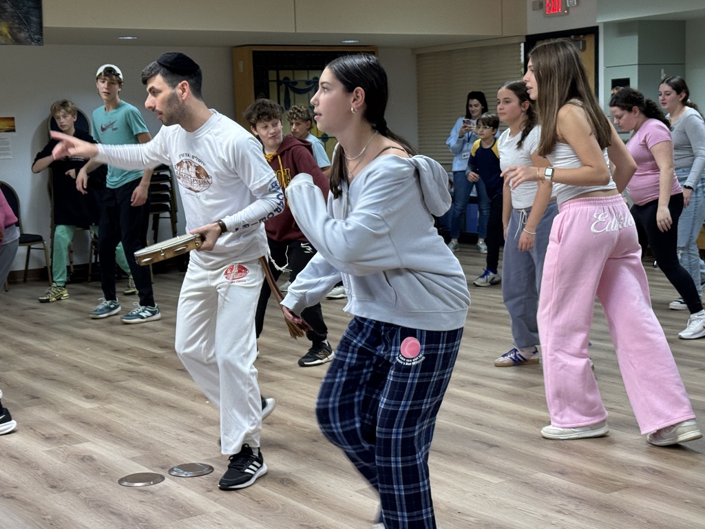 Miki Chayat leads middle school in capoeira moves