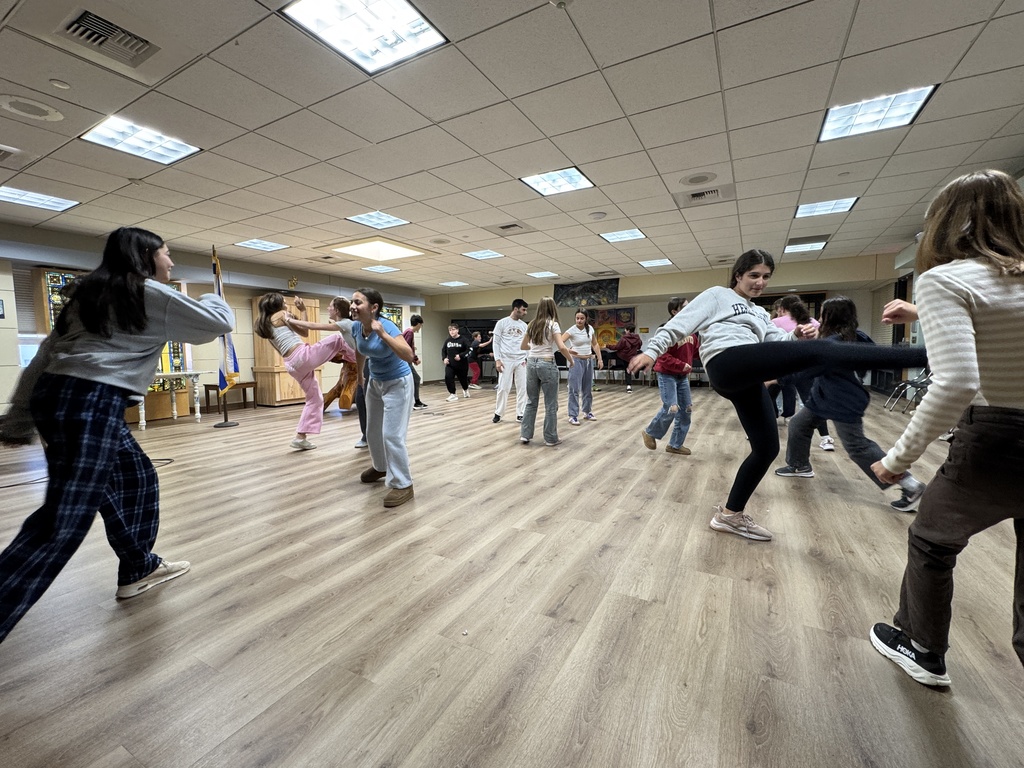 middle schoolers practice capoeira moves