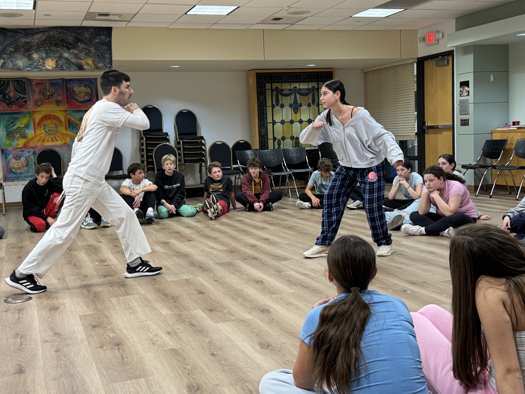 Miki Chayat and student demonstrate capoeira move