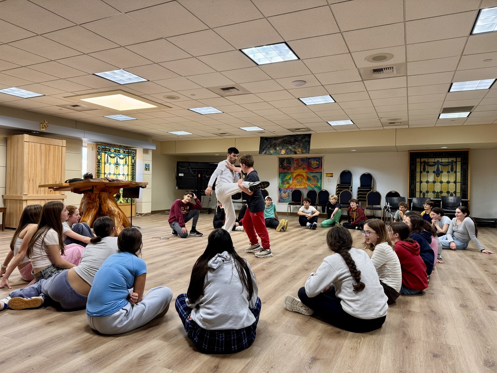 Miki Chayat and student demonstrate capoeira move