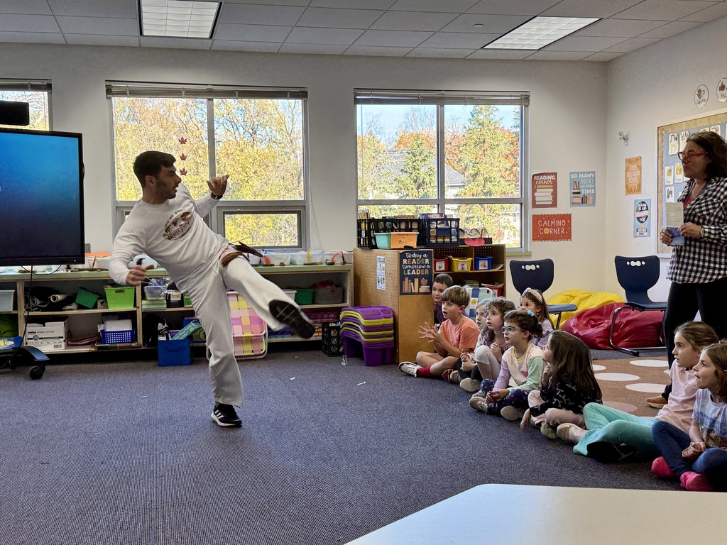 Miki Chayat shows first graders capoeira moves