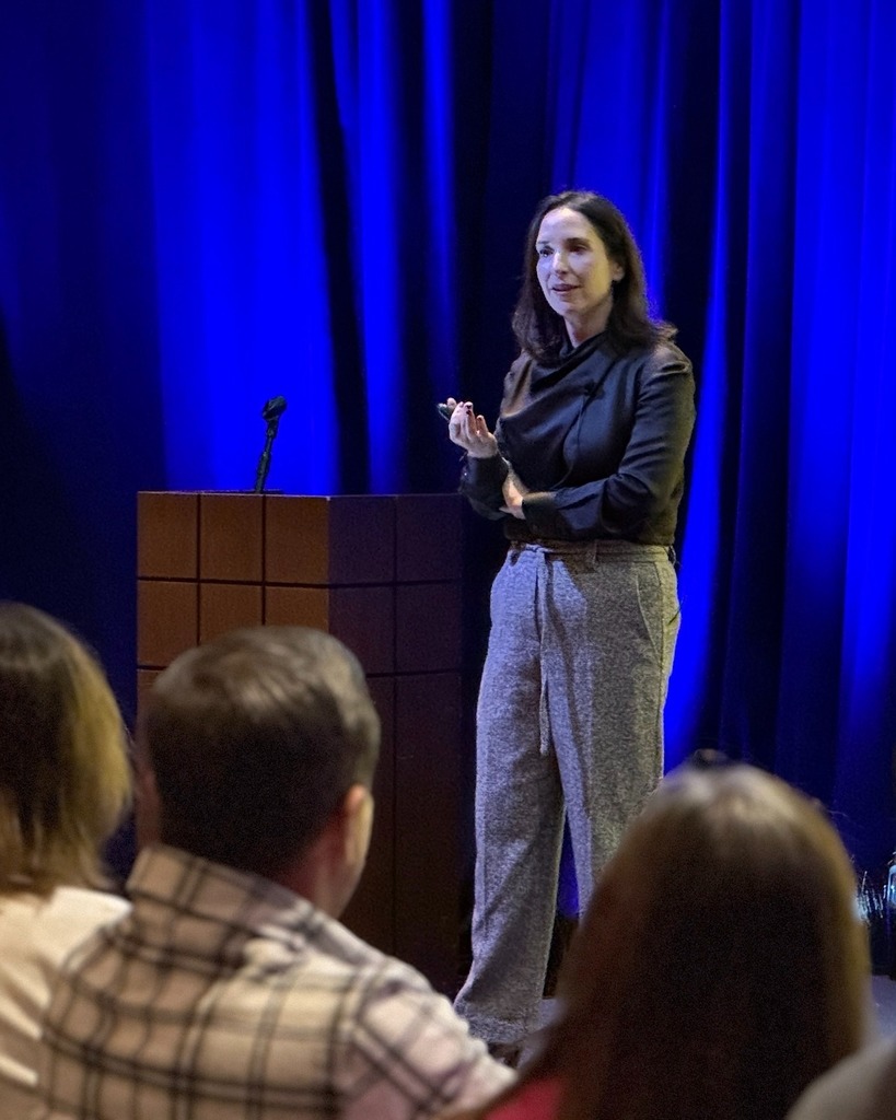 Kim Lear speaks in front of audience
