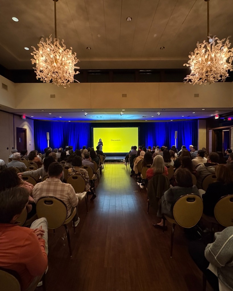 Kim Lear speaks in front of audience