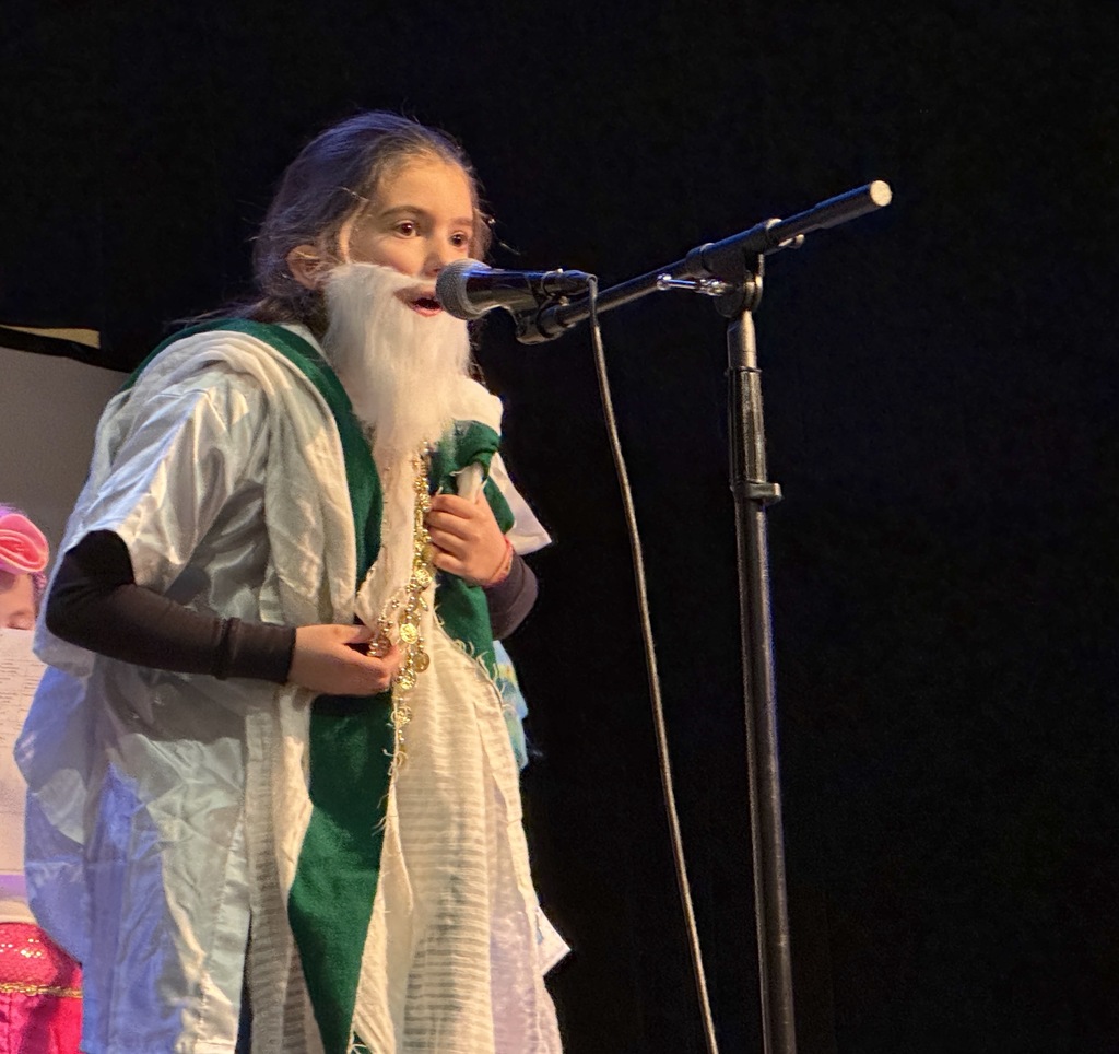 first grader speaks into microphone