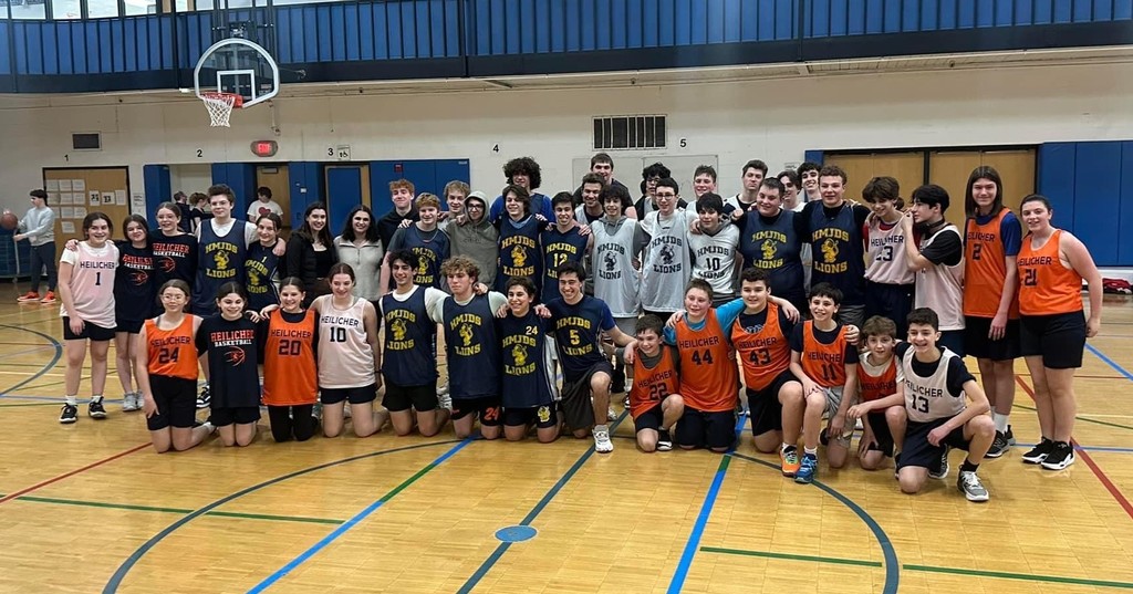 students and alumni at annual basketball game against each other