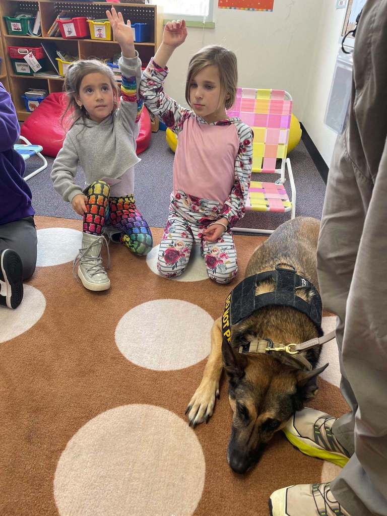 students ask questions about security dog