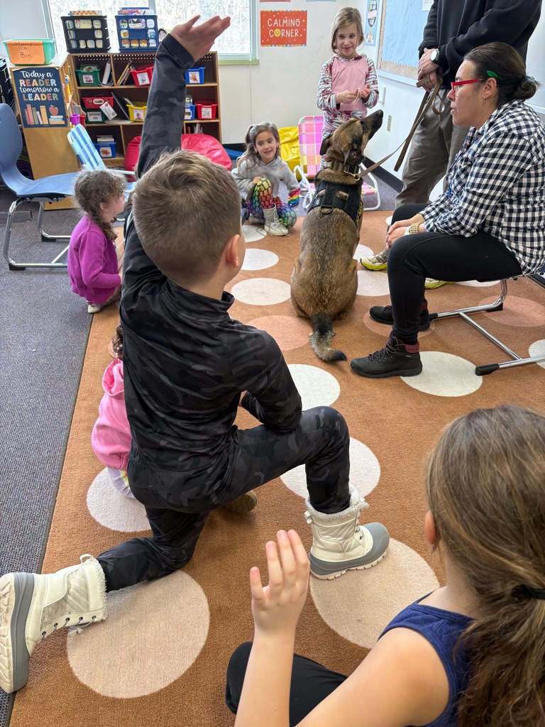 students ask questions about security dog