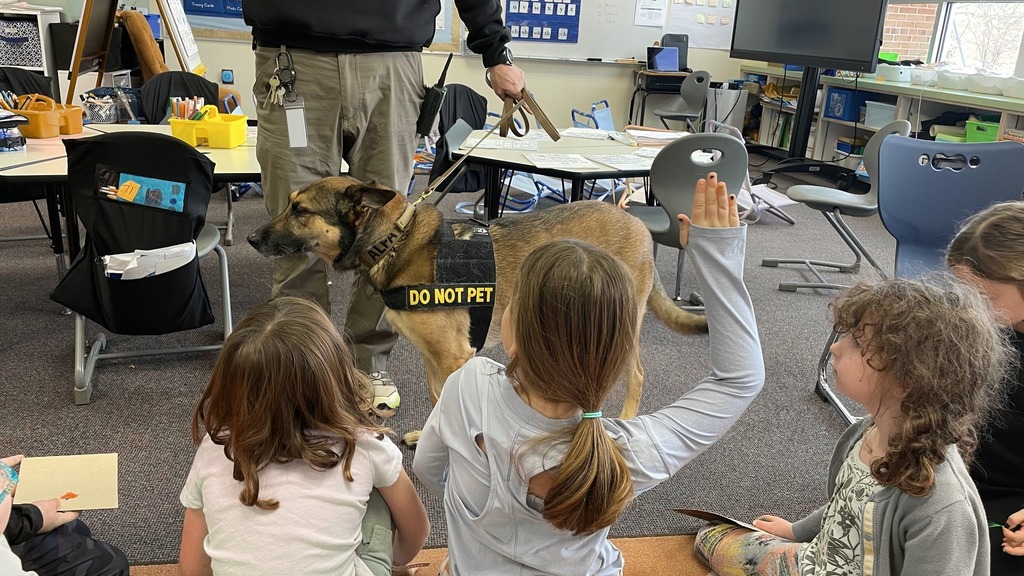 students ask questions about security dog