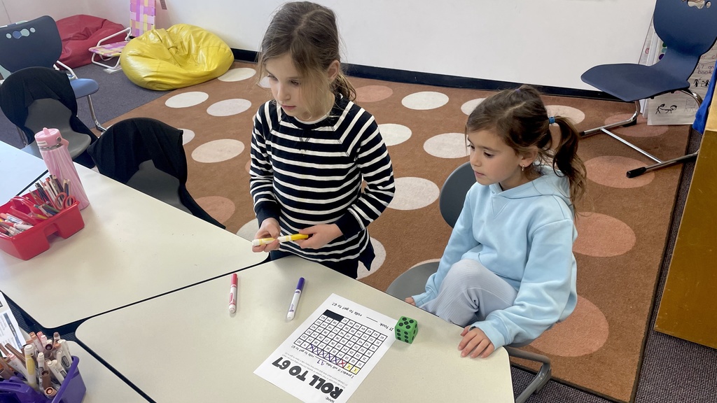 students rolls dice to count to 67