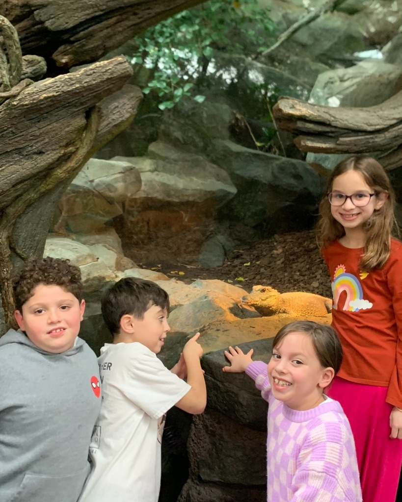 students pose with reptile