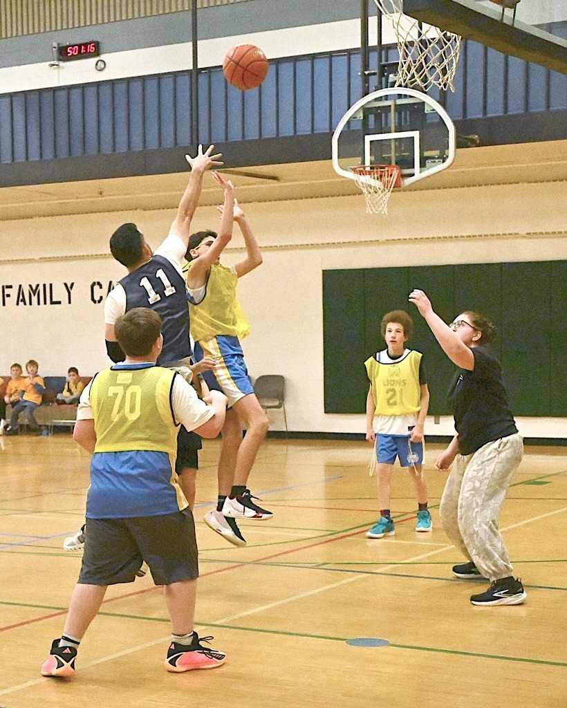 student shoots basketball