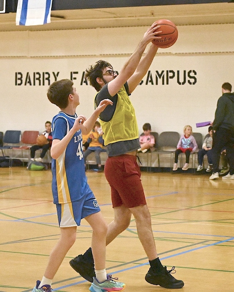 student and alum play basketball