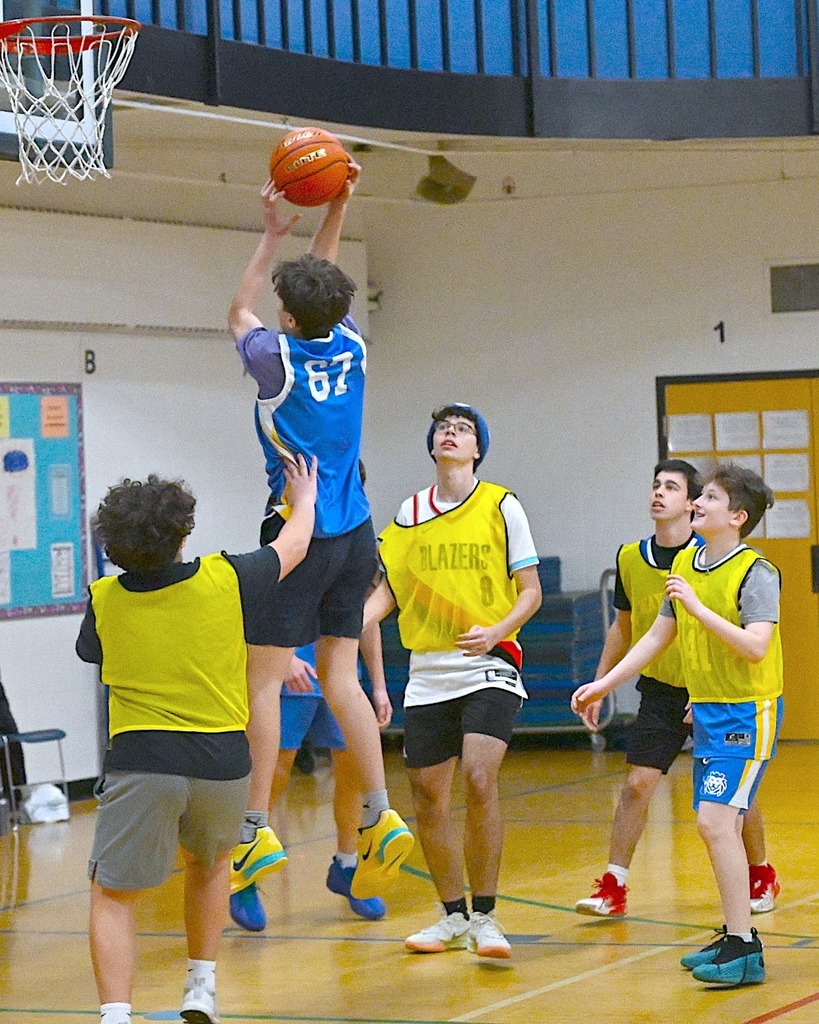 student shoots basketball