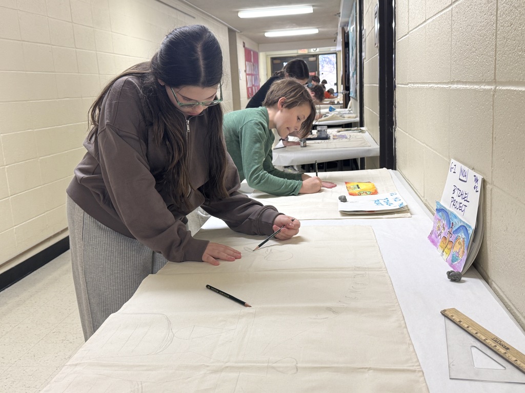 students sketch talit design onto fabric