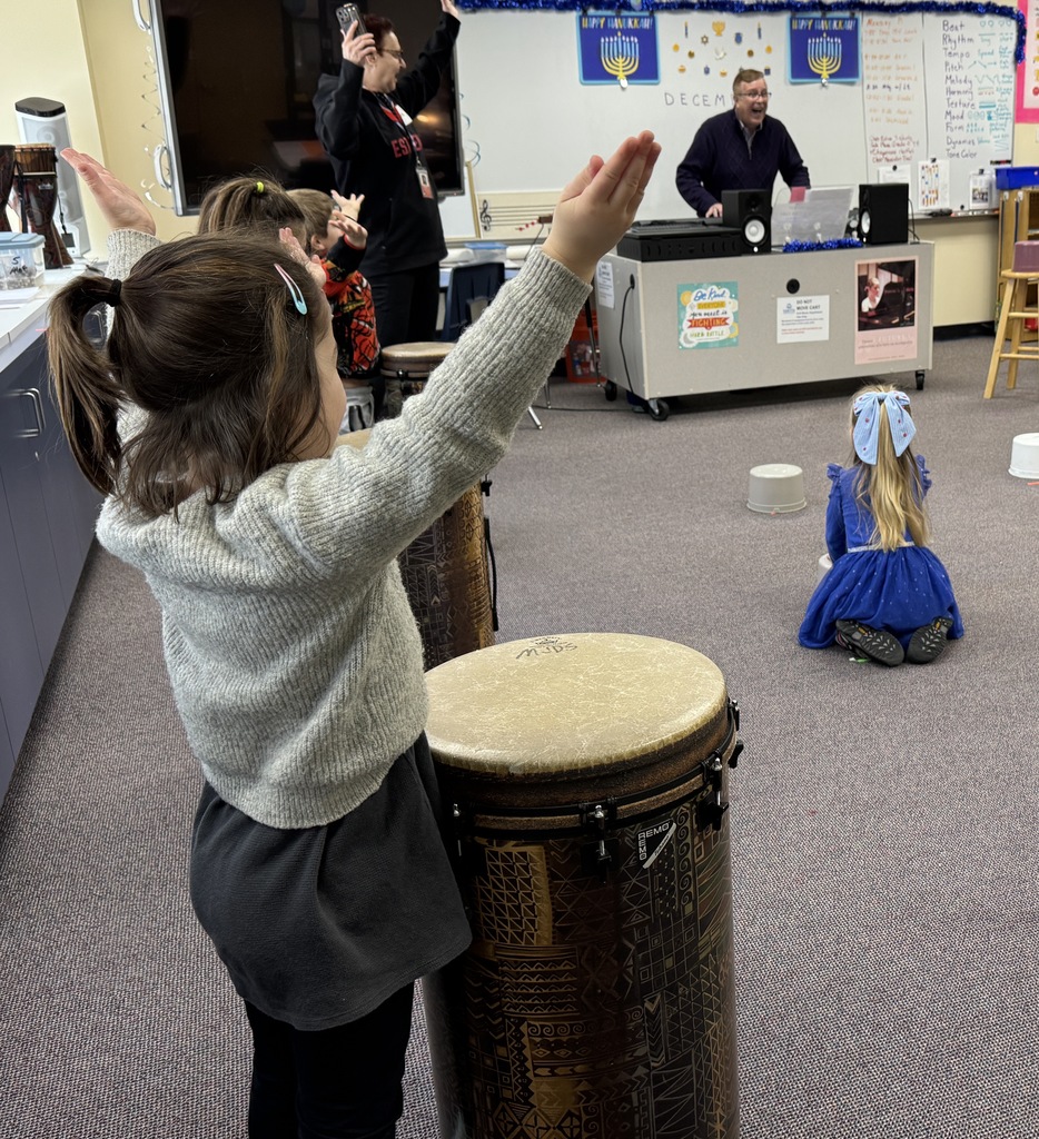 pre-k students drum rhythms with SJA music teacher
