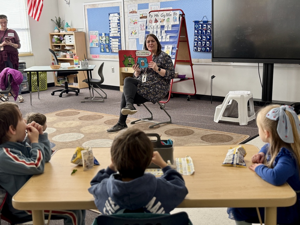 SJA kindergarten teacher reads to pre-k students