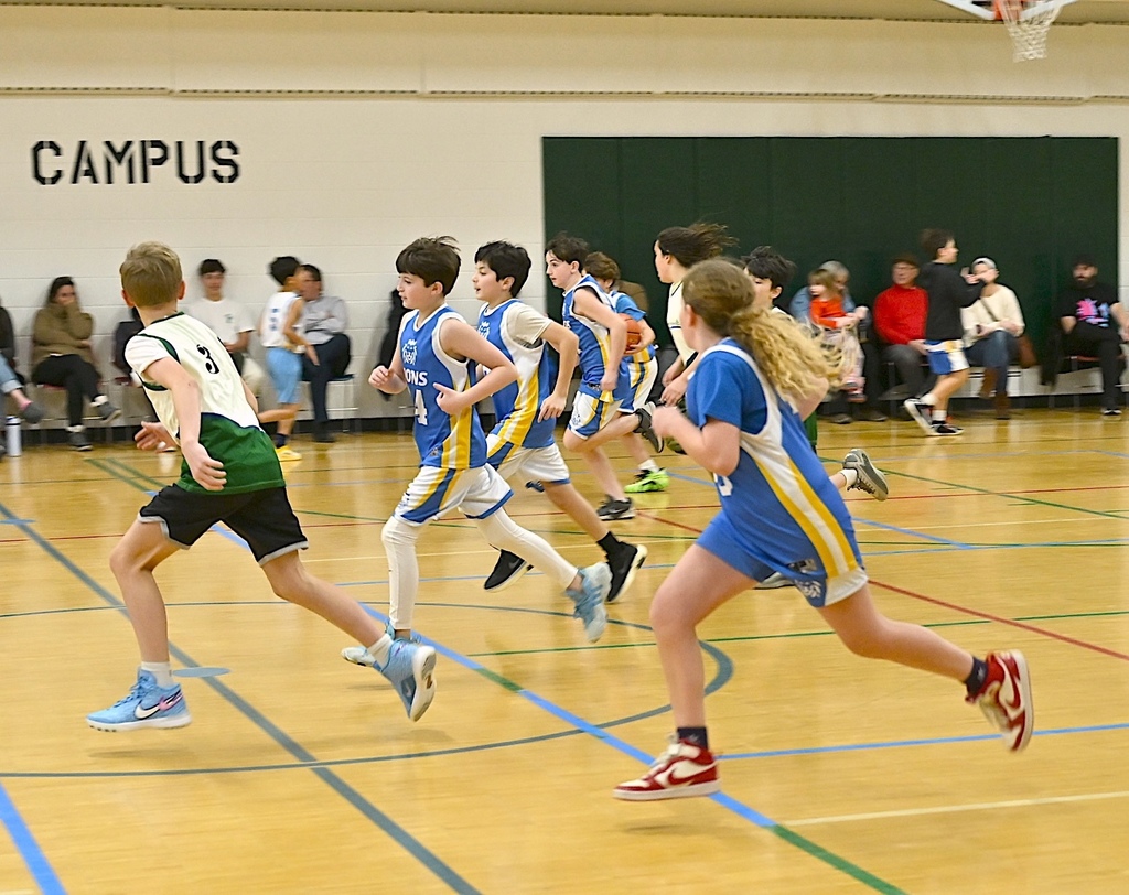 basketball players run down the court