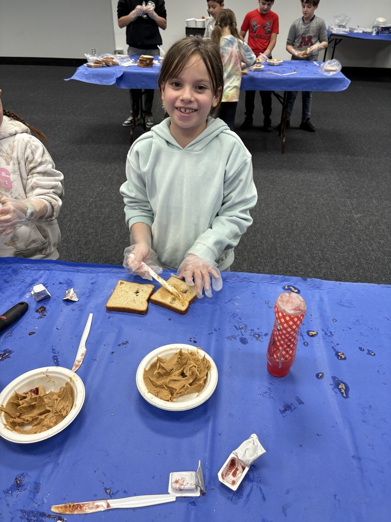 student makes sandwiches for The Sandwich Project