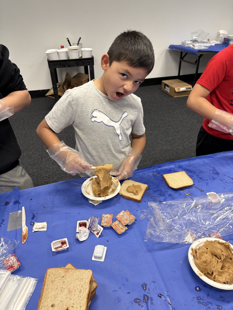 student makes sandwiches for The Sandwich Project